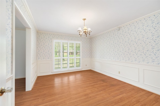 1908 Oak Shadows St, Baytown, TX 77520 - unfurnished room featuring ornamental molding, a chandelier, a wainscoted wall, light wood-style floors, and wallpapered walls