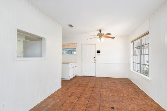 1908 Oak Shadows St, Baytown, TX 77520 - entrance foyer with healthy amount of natural light, a ceiling fan, and a wainscoted wall