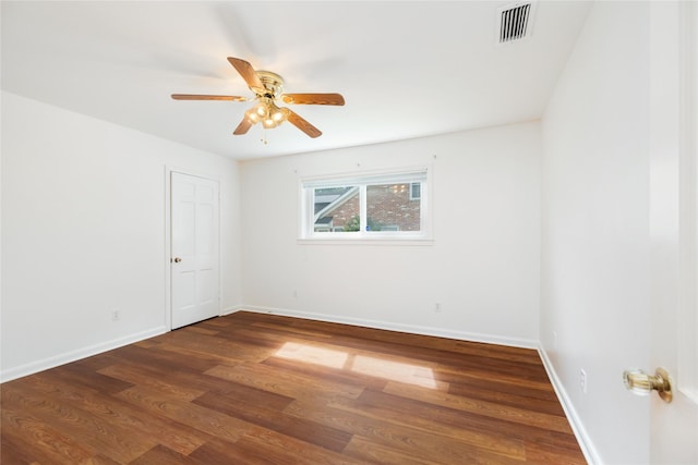 1908 Oak Shadows St, Baytown, TX 77520 - spare room with dark wood-type flooring, ceiling fan, and baseboards