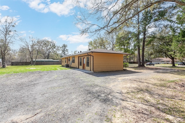 105A Butler Rd, Vidor, TX 77662 - view of property exterior featuring gravel driveway and cooling unit