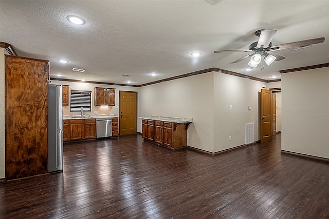 105A Butler Rd, Vidor, TX 77662 - kitchen with a sink, stainless steel appliances, dark wood-type flooring, ornamental molding, and ceiling fan