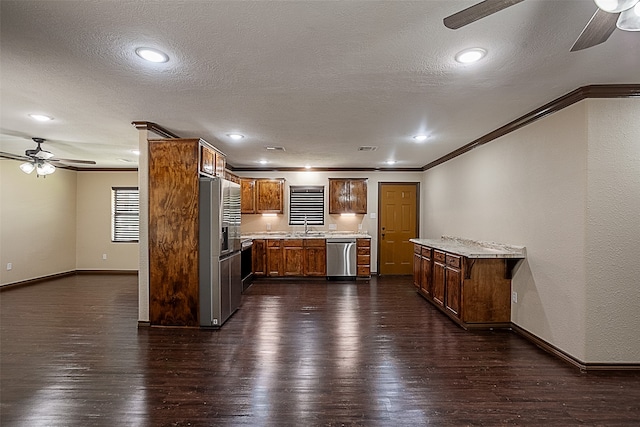 105A Butler Rd, Vidor, TX 77662 - kitchen featuring ceiling fan, stainless steel appliances, crown molding, dark wood-type flooring, and baseboards