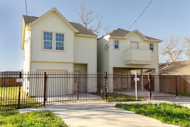 7754 Ave J, Houston, TX 77012 - view of front of house with a garage, driveway, a fenced front yard, roof with shingles, and a balcony