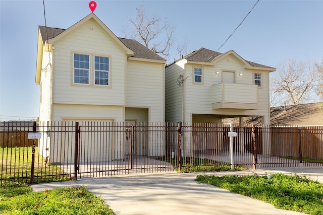 7754 Ave J, Houston, TX 77012 - view of front of home featuring concrete driveway, a garage, a fenced front yard, a shingled roof, and a balcony