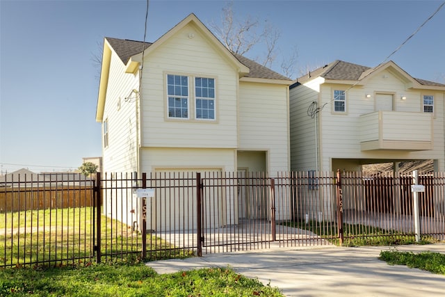 7754 Ave J, Houston, TX 77012 - view of front facade featuring roof with shingles, driveway, a fenced front yard, and a garage