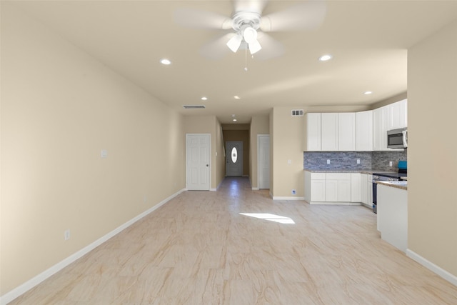7754 Ave J, Houston, TX 77012 - kitchen featuring stainless steel appliances, white cabinetry, tasteful backsplash, recessed lighting, and a ceiling fan