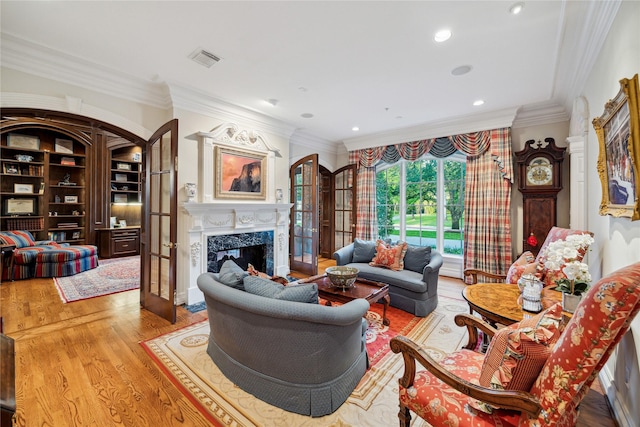 10911 Kemwood Dr, Houston, TX 77024 - living area featuring a premium fireplace, crown molding, wood finished floors, and recessed lighting