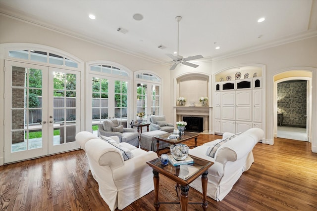 10911 Kemwood Dr, Houston, TX 77024 - living room with french doors, crown molding, ceiling fan, wood finished floors, and a fireplace