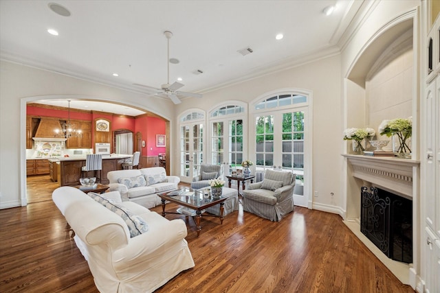 10911 Kemwood Dr, Houston, TX 77024 - living area with a fireplace, arched walkways, ornamental molding, ceiling fan, and wood finished floors