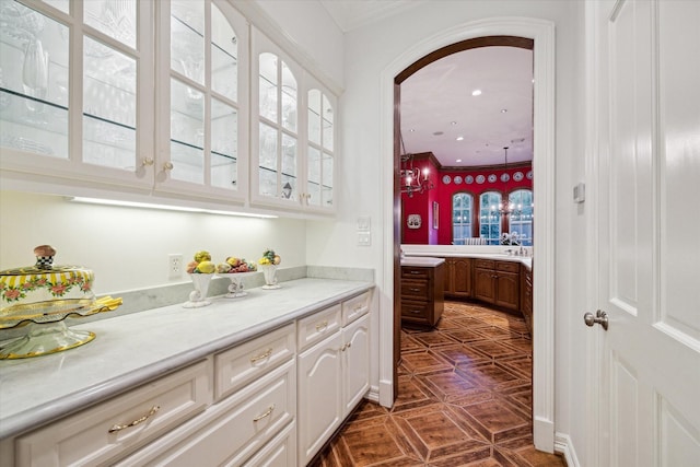 10911 Kemwood Dr, Houston, TX 77024 - bar area featuring arched walkways and crown molding