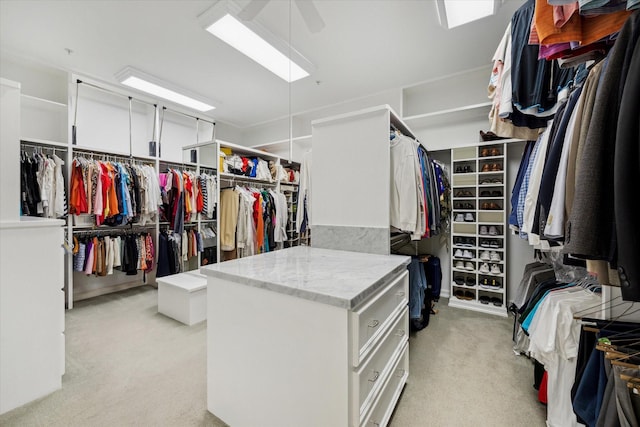 10911 Kemwood Dr, Houston, TX 77024 - walk in closet with light colored carpet and ceiling fan