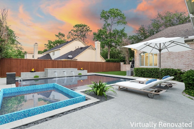 10911 Kemwood Dr, Houston, TX 77024 - pool at dusk featuring a fenced backyard, a patio area, and central AC