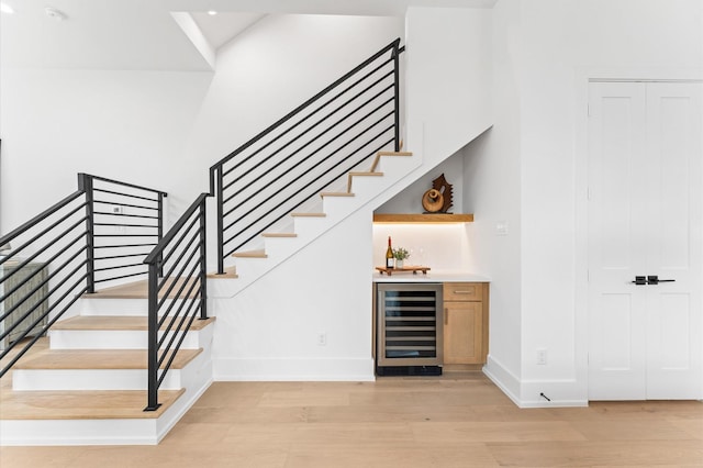 819 Dorothy St Unit B, Houston, TX 77008 - stairway with wine cooler, wood finished floors, bar, baseboards, and recessed lighting