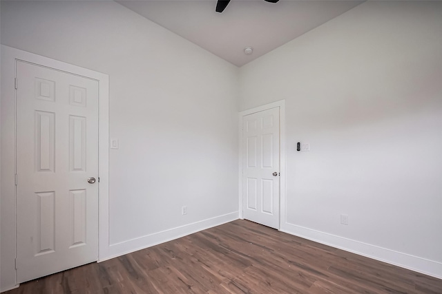 7993 Attwater St, Houston, TX 77028 - empty room with ceiling fan, dark wood finished floors, baseboards, lofted ceiling, and a smoke detector