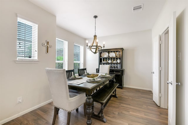 13823 Pointed Edge Ln, Cypress, TX 77429 - dining area featuring a chandelier, wood finished floors, and baseboards
