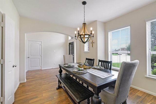 13823 Pointed Edge Ln, Cypress, TX 77429 - dining room with arched walkways, a chandelier, and baseboards
