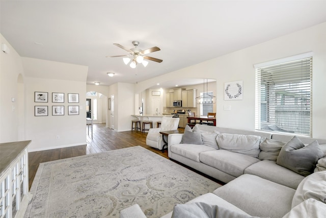 13823 Pointed Edge Ln, Cypress, TX 77429 - living area featuring arched walkways, a ceiling fan, and dark wood-style floors