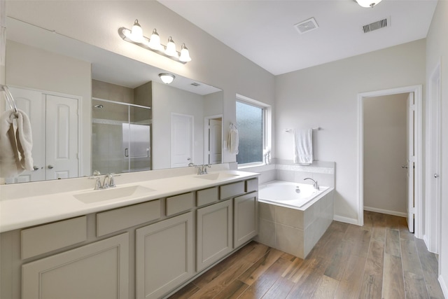 13823 Pointed Edge Ln, Cypress, TX 77429 - full bath featuring a stall shower, a bath, double vanity, wood finished floors, and baseboards