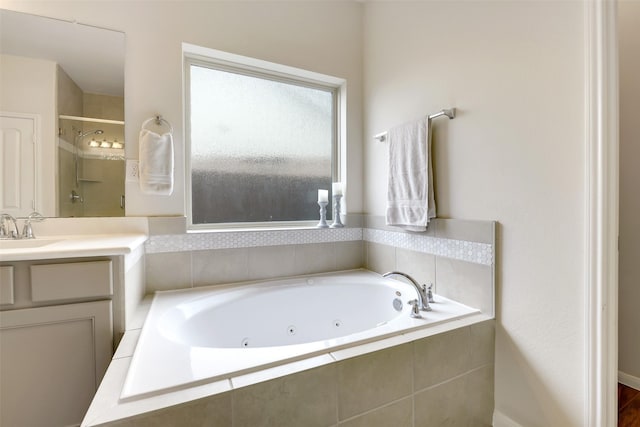 13823 Pointed Edge Ln, Cypress, TX 77429 - bathroom featuring a tub with jets, vanity, and a shower