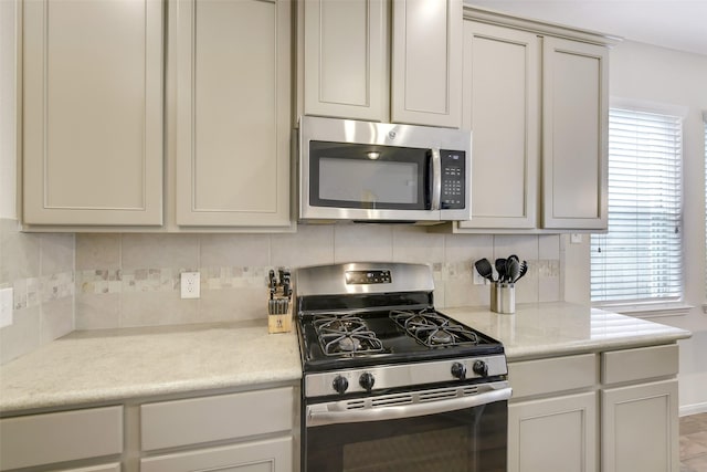 13823 Pointed Edge Ln, Cypress, TX 77429 - kitchen with appliances with stainless steel finishes, backsplash, light countertops, and baseboards