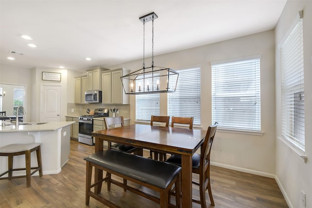13823 Pointed Edge Ln, Cypress, TX 77429 - dining space featuring a chandelier, wood finished floors, baseboards, and recessed lighting