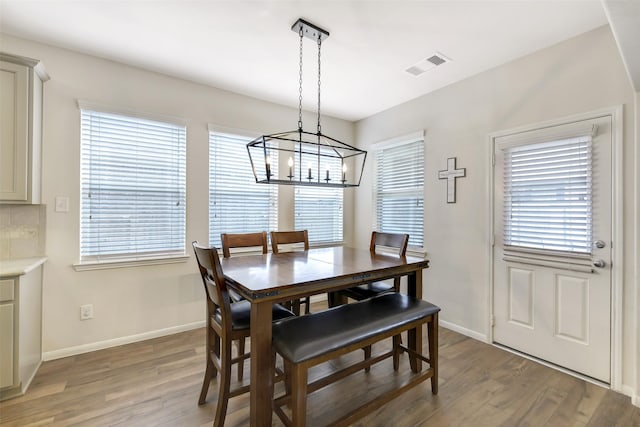 13823 Pointed Edge Ln, Cypress, TX 77429 - dining area featuring light wood-style floors, baseboards, and a chandelier