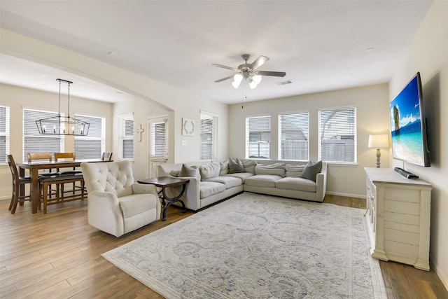 13823 Pointed Edge Ln, Cypress, TX 77429 - living room with a ceiling fan, wood finished floors, a chandelier, and baseboards