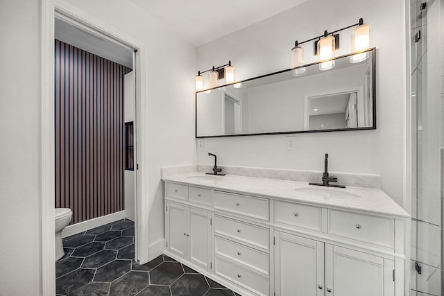1931 Chaparral Dr, Houston, TX 77043 - full bathroom with double vanity, toilet, and tile patterned floors