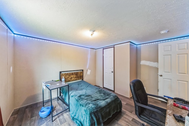 17968 County Road 426, Brazoria, TX 77422 - bedroom with a textured ceiling and wood finished floors