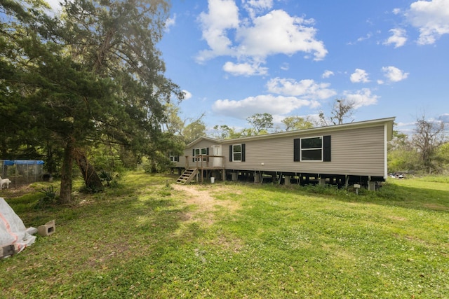 17968 County Road 426, Brazoria, TX 77422 - back of property featuring a lawn, a wooden deck, and stairway