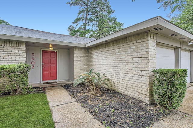5607 Circlegate Dr, Spring, TX 77373 - view of exterior entry featuring brick siding and a garage