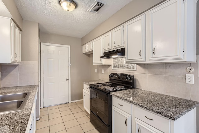 5607 Circlegate Dr, Spring, TX 77373 - kitchen with black / electric stove, under cabinet range hood, white cabinets, decorative backsplash, and light tile patterned floors