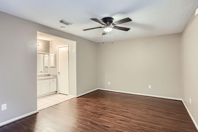 5607 Circlegate Dr, Spring, TX 77373 - unfurnished bedroom featuring wood finished floors, baseboards, connected bathroom, and a ceiling fan