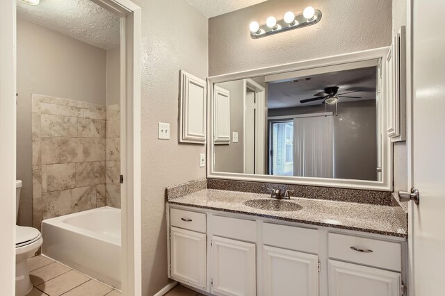 5607 Circlegate Dr, Spring, TX 77373 - full bathroom featuring toilet, vanity, ceiling fan, a textured wall, and tile patterned flooring