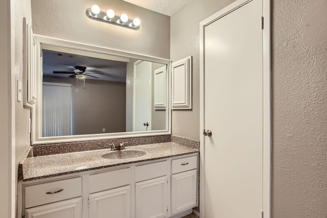 5607 Circlegate Dr, Spring, TX 77373 - bathroom featuring a textured wall, vanity, and a ceiling fan