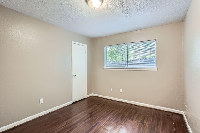 5607 Circlegate Dr, Spring, TX 77373 - spare room featuring dark wood finished floors, baseboards, and a textured ceiling