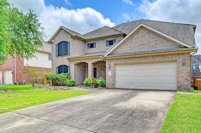 1752 Cypress Meadows Dr, Dickinson, TX 77539 - french provincial home featuring brick siding, concrete driveway, roof with shingles, a front yard, and an attached garage