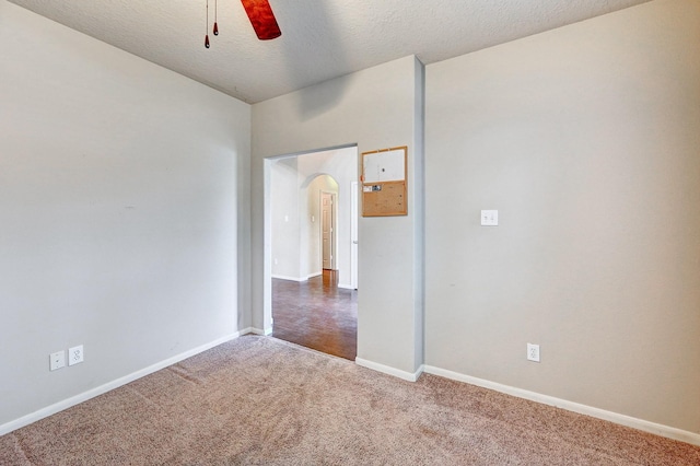 1752 Cypress Meadows Dr, Dickinson, TX 77539 - carpeted spare room with ceiling fan, arched walkways, baseboards, and a textured ceiling
