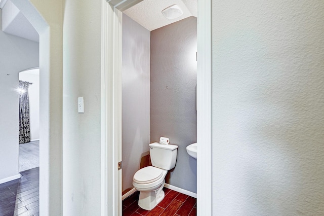 1752 Cypress Meadows Dr, Dickinson, TX 77539 - bathroom with wood tiled floors, toilet, and baseboards
