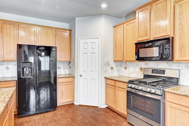 1752 Cypress Meadows Dr, Dickinson, TX 77539 - kitchen featuring black appliances, light brown cabinetry, decorative backsplash, a textured ceiling, and recessed lighting