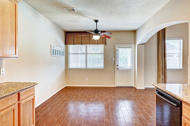 1752 Cypress Meadows Dr, Dickinson, TX 77539 - unfurnished dining area with a ceiling fan, dark wood-style floors, a textured ceiling, and baseboards