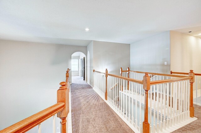 1752 Cypress Meadows Dr, Dickinson, TX 77539 - hall featuring carpet, an upstairs landing, arched walkways, recessed lighting, and baseboards