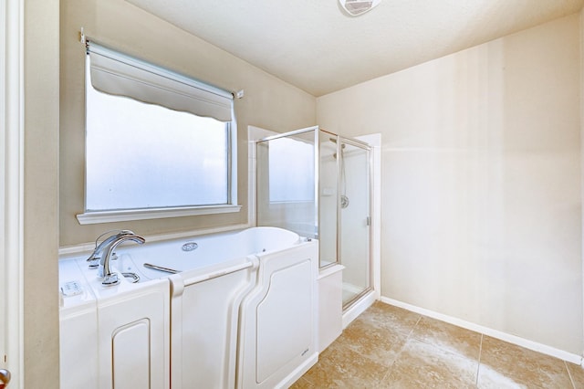 1752 Cypress Meadows Dr, Dickinson, TX 77539 - bathroom featuring a stall shower, a bath, baseboards, and tile patterned flooring