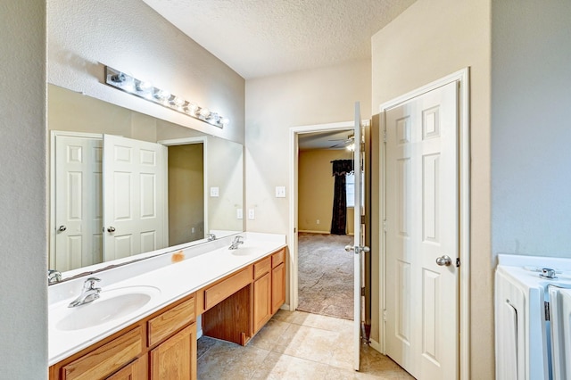 1752 Cypress Meadows Dr, Dickinson, TX 77539 - full bathroom with a textured ceiling, ceiling fan, double vanity, and tile patterned flooring