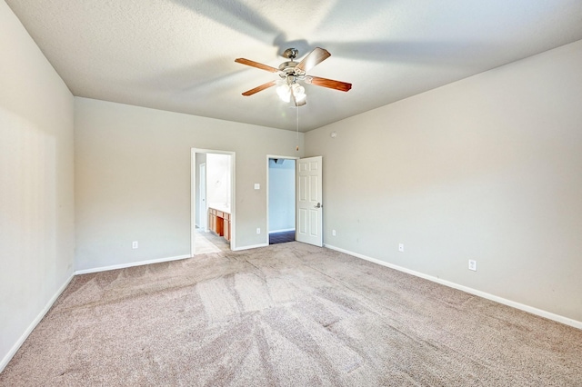 1752 Cypress Meadows Dr, Dickinson, TX 77539 - unfurnished bedroom featuring light carpet, baseboards, connected bathroom, and ceiling fan