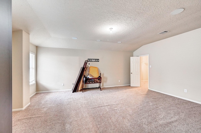 1752 Cypress Meadows Dr, Dickinson, TX 77539 - carpeted spare room with a textured ceiling, baseboards, and vaulted ceiling