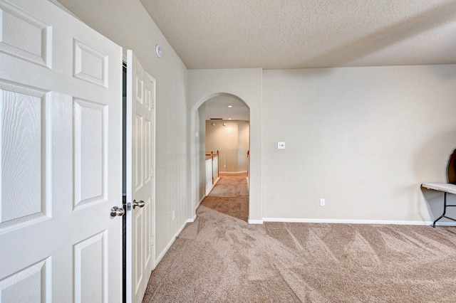 1752 Cypress Meadows Dr, Dickinson, TX 77539 - carpeted empty room with arched walkways, baseboards, and a textured ceiling