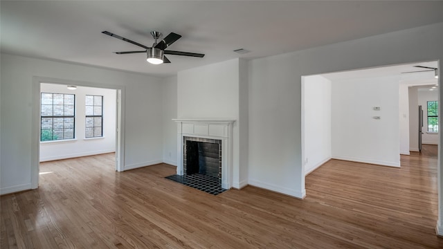 2308 Blodgett St, Houston, TX 77004 - unfurnished living room featuring ceiling fan, wood finished floors, a fireplace, and baseboards