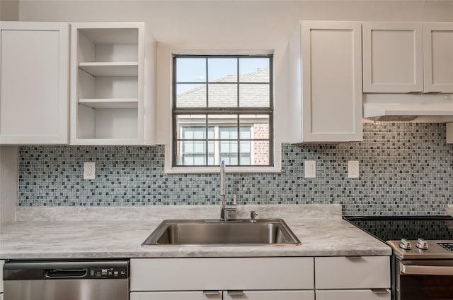 2308 Blodgett St, Houston, TX 77004 - kitchen with appliances with stainless steel finishes, a sink, under cabinet range hood, white cabinets, and light countertops