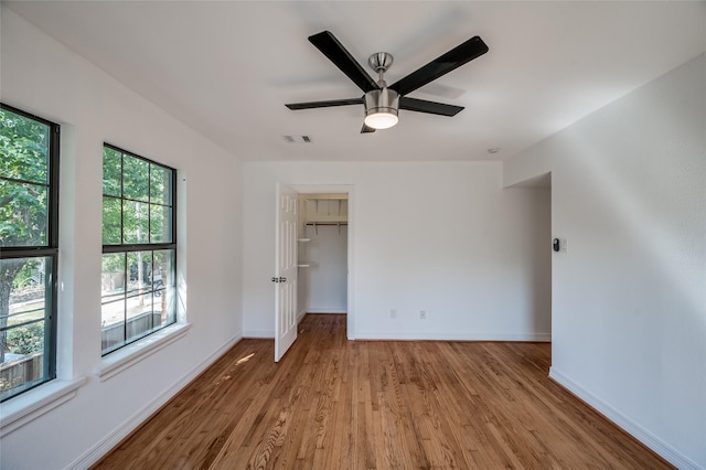 2308 Blodgett St, Houston, TX 77004 - unfurnished bedroom featuring wood finished floors, baseboards, a spacious closet, ceiling fan, and a closet